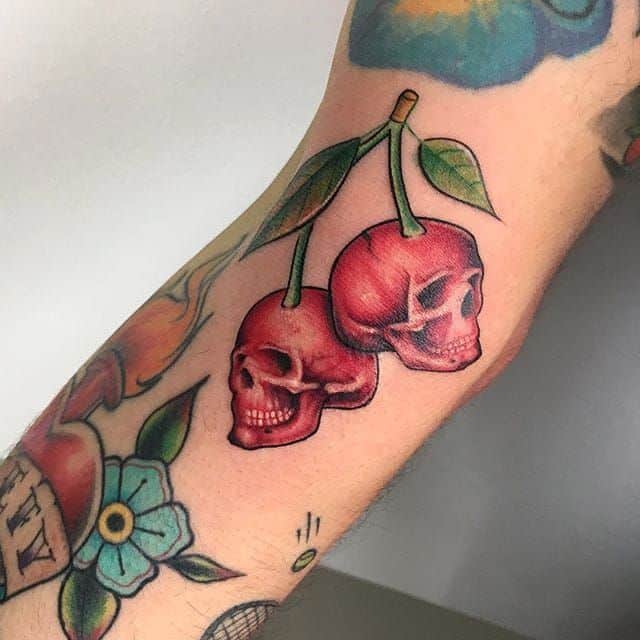 Cherry and a skull tattoo