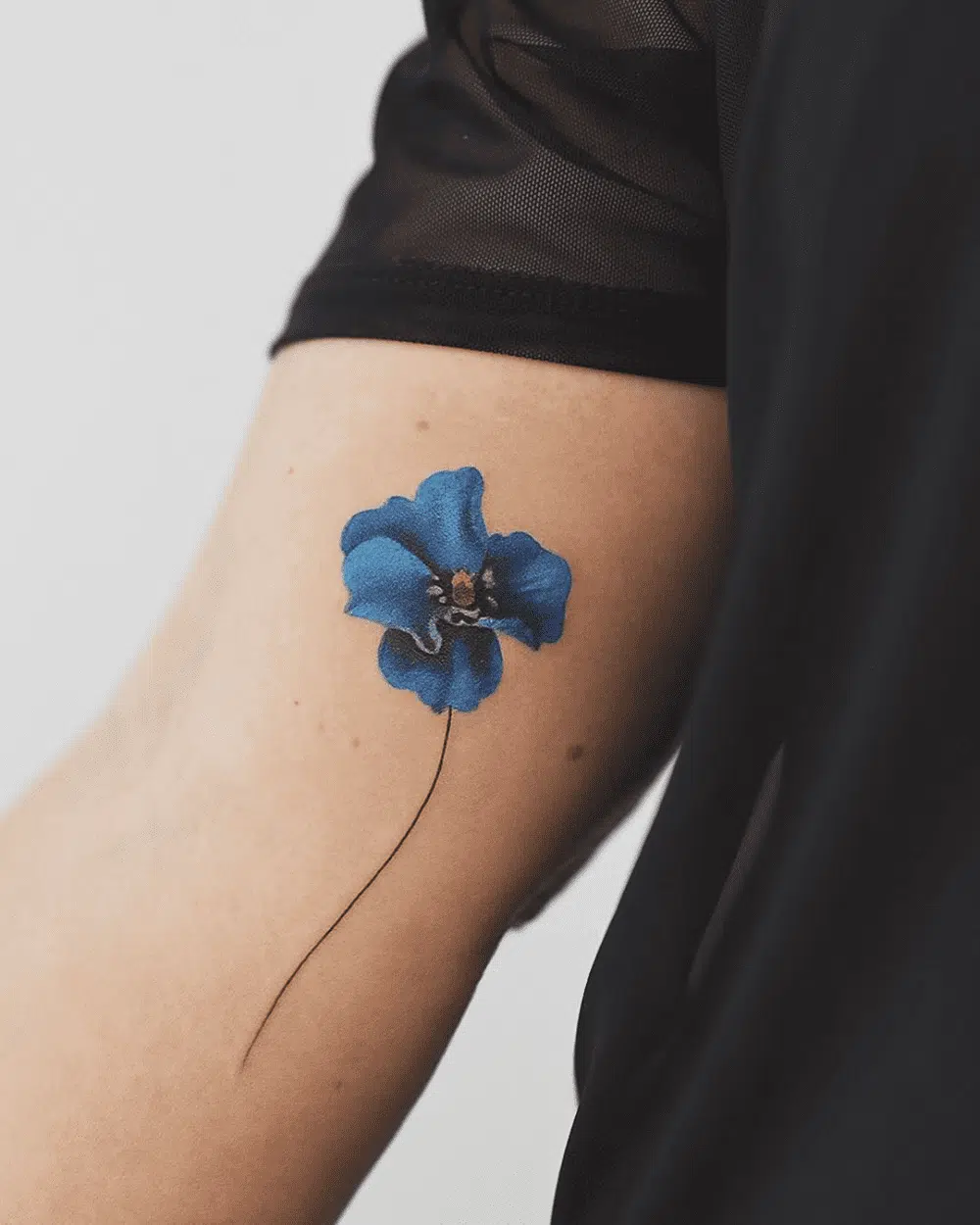 Blue poppy flower tattoos