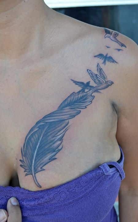 Feather chest tattoos for women