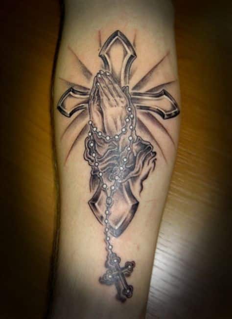 Praying hands with a cross tattoo