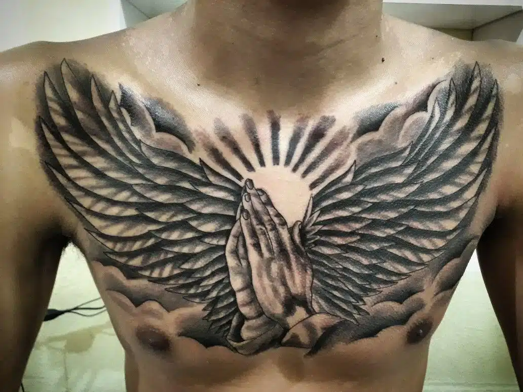 Praying hands with angel wings tattoo