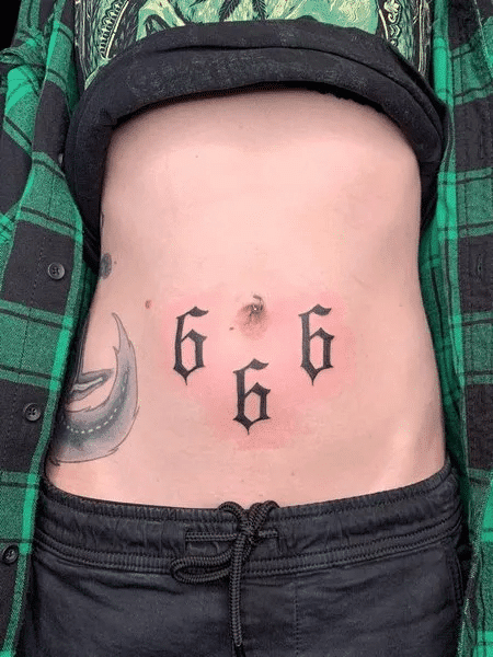 Abdomen 666 angel number tattoo