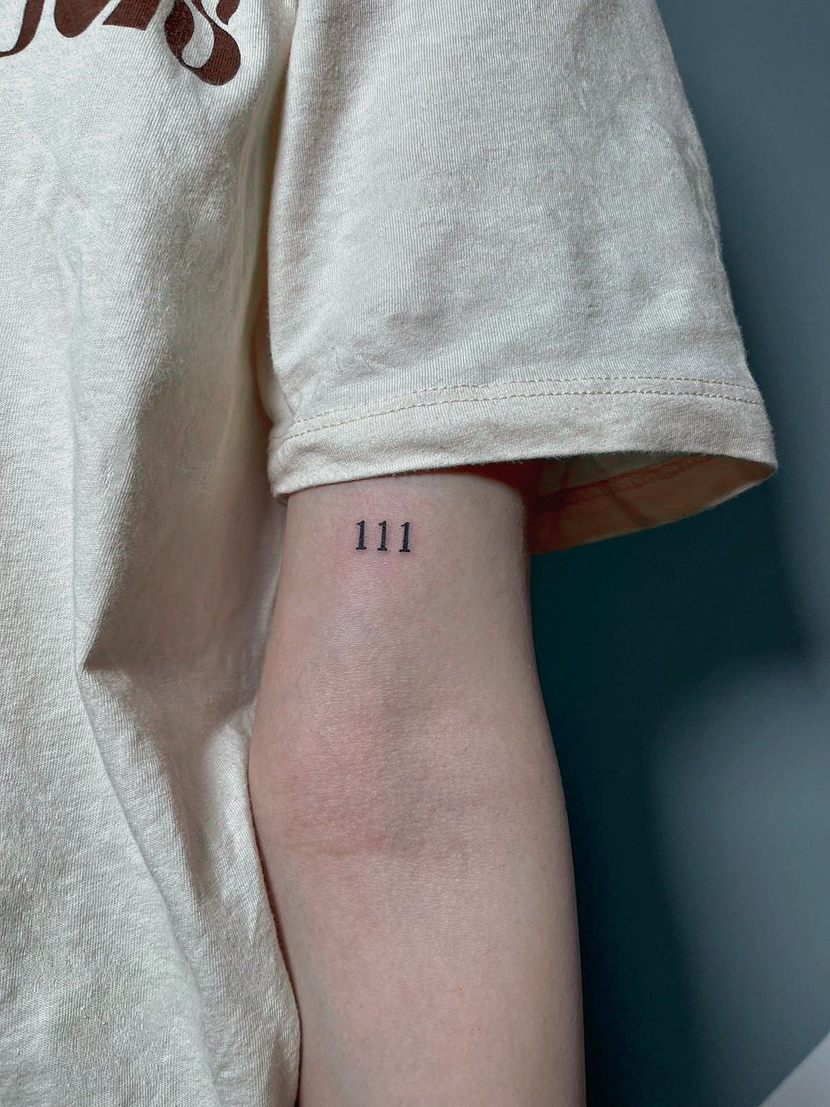 Arm 111 angel number tattoo