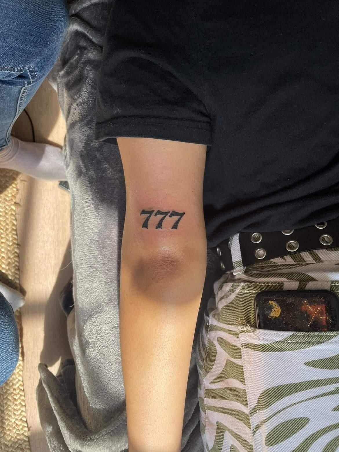 Elbow 777 angel number tattoo