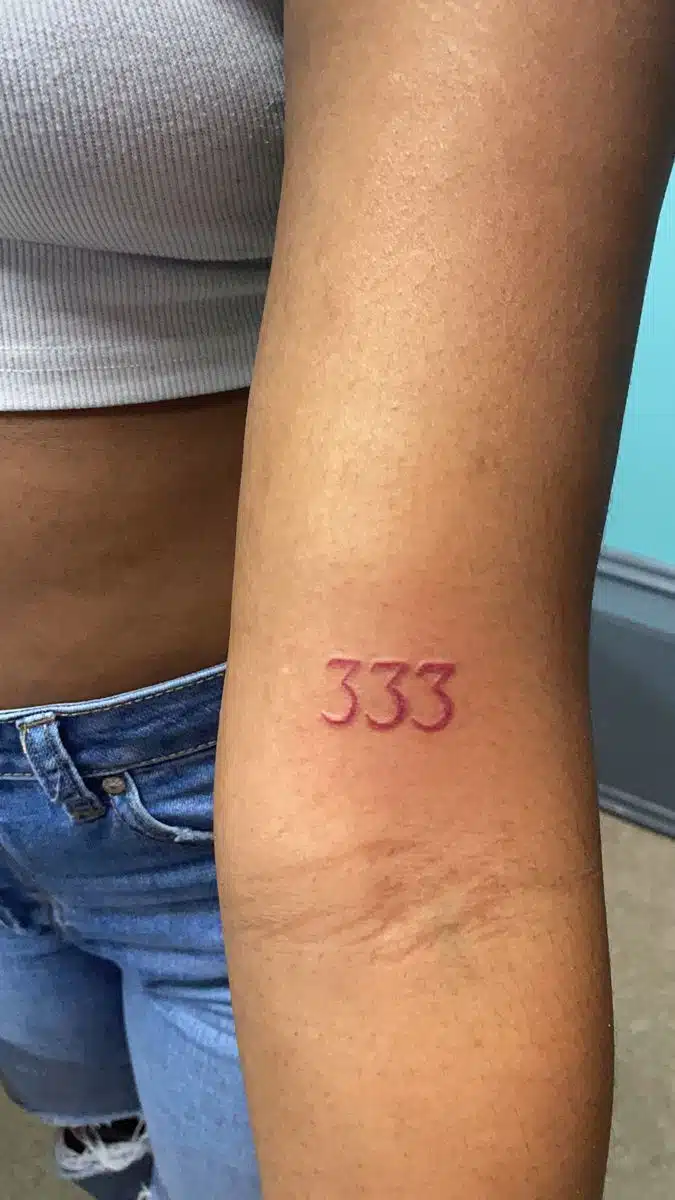 Upper arm 333 angel number tattoo